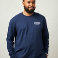 Man wearing a navy blue long sleeve unisex shirt with a small white Everytown for Gun Safety logo printed on left chest.