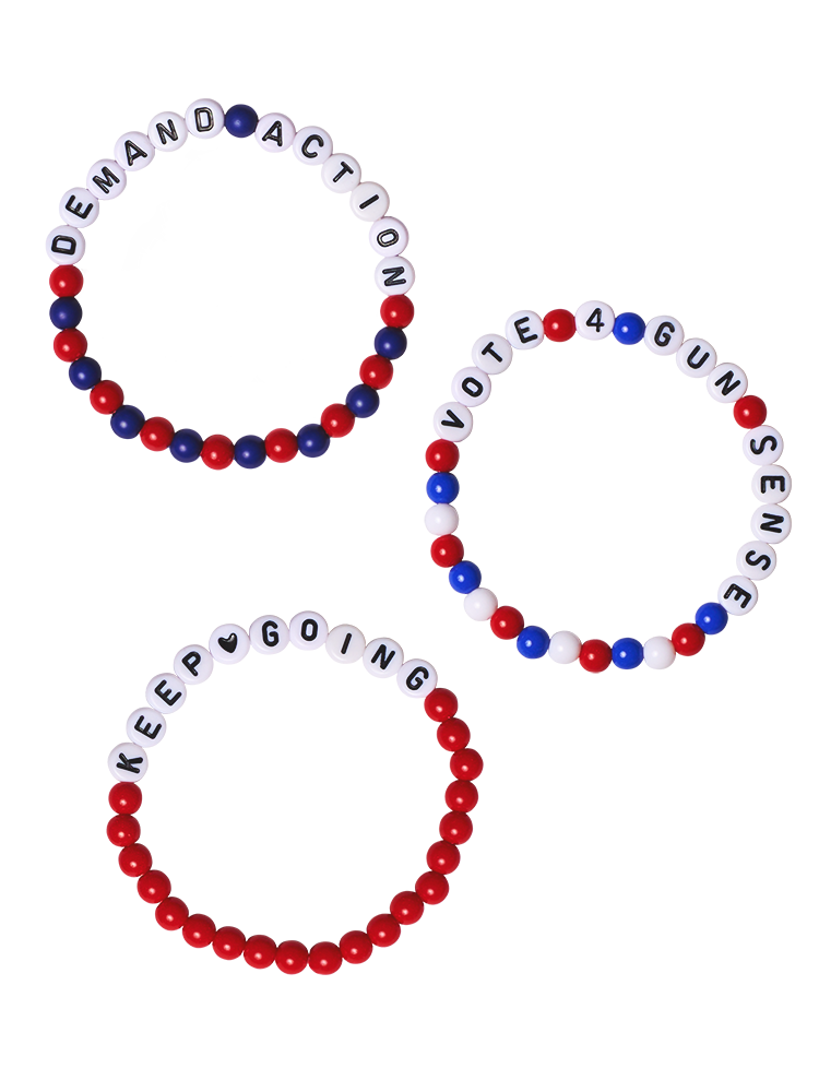 Three beaded friendship bracelets. First bracelet reads Demand Action with alternating red and blue beads. Second bracelet reads Vote 4 Gun Sense surrounded by red, white, and blue beads. Third bracelet reads Keep Going, with a heart between the words, surrounded by red beads.