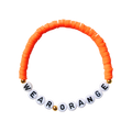 Beaded friendship bracelet with orange and gold beads. White beads with black letters spell out "WEAR ORANGE."