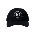 Front view of a black baseball cap with white embroidery reading "Moms Demand Action 10 Years, Est. 2012"