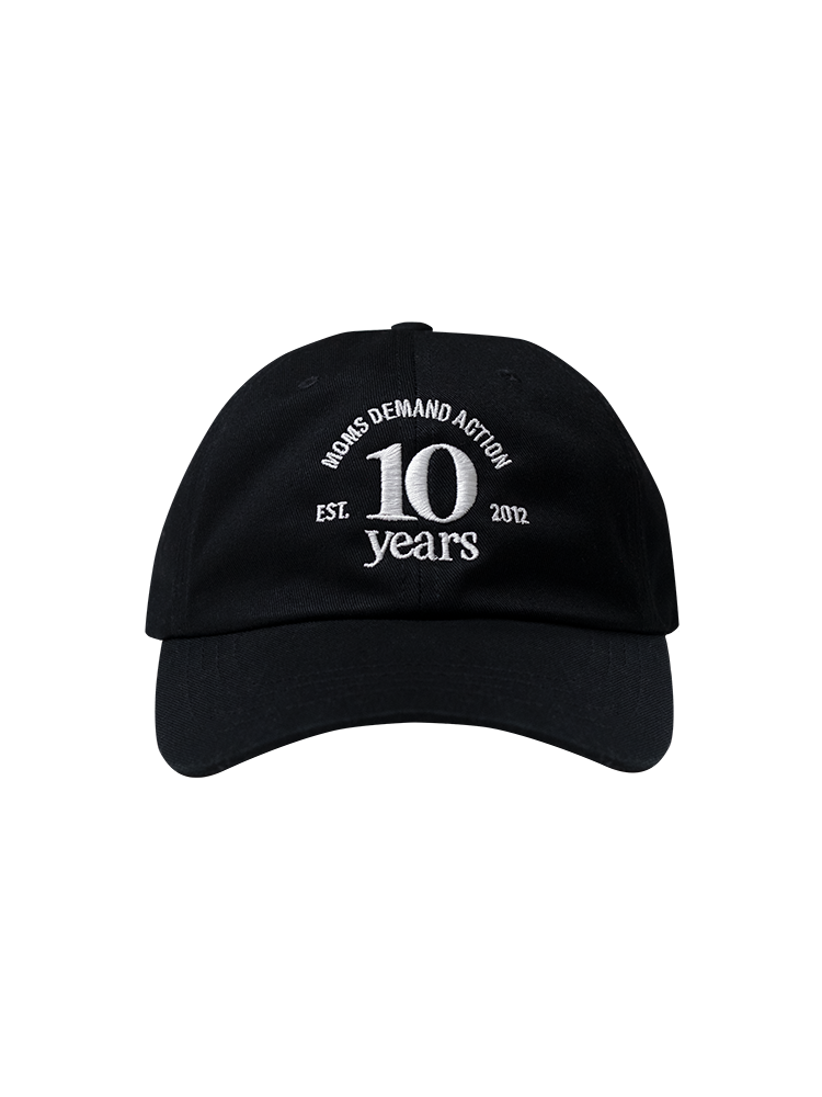 Front view of a black baseball cap with white embroidery reading "Moms Demand Action 10 Years, Est. 2012"