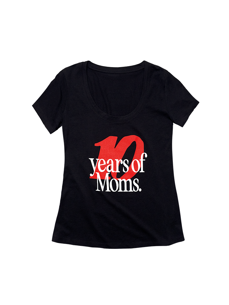 Front view of a black short sleeve scoop neck women's cut tee shirt. A large red "10" is printed with overlapping white text that reads "years of Moms."